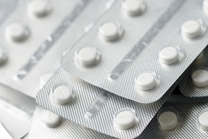 Close up of white medicine pills forming background